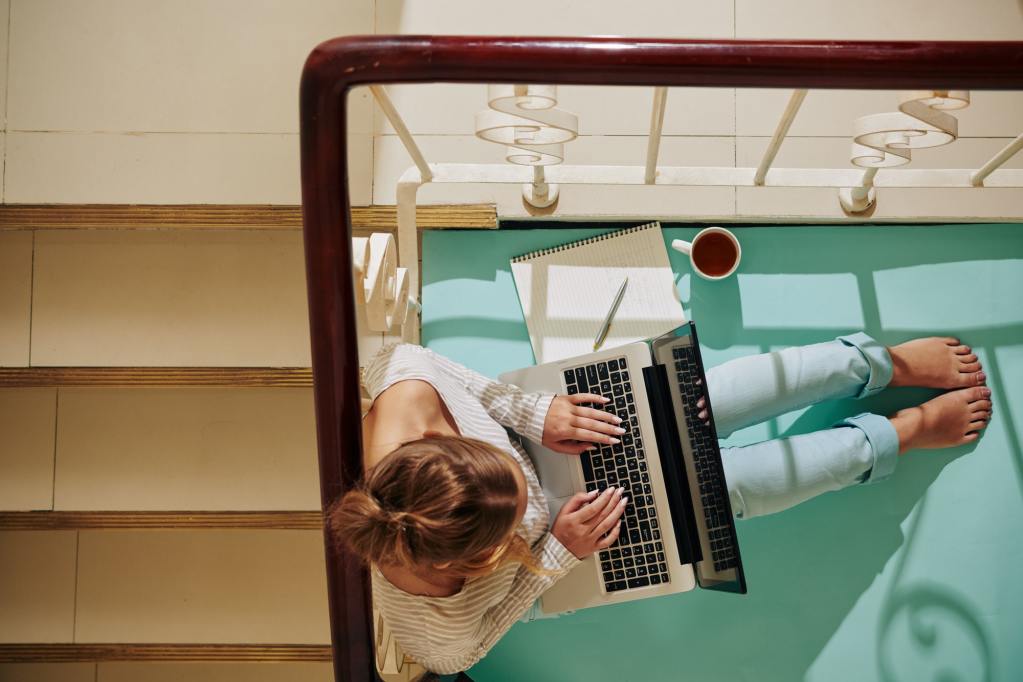 Woman With Laptop On Staircase