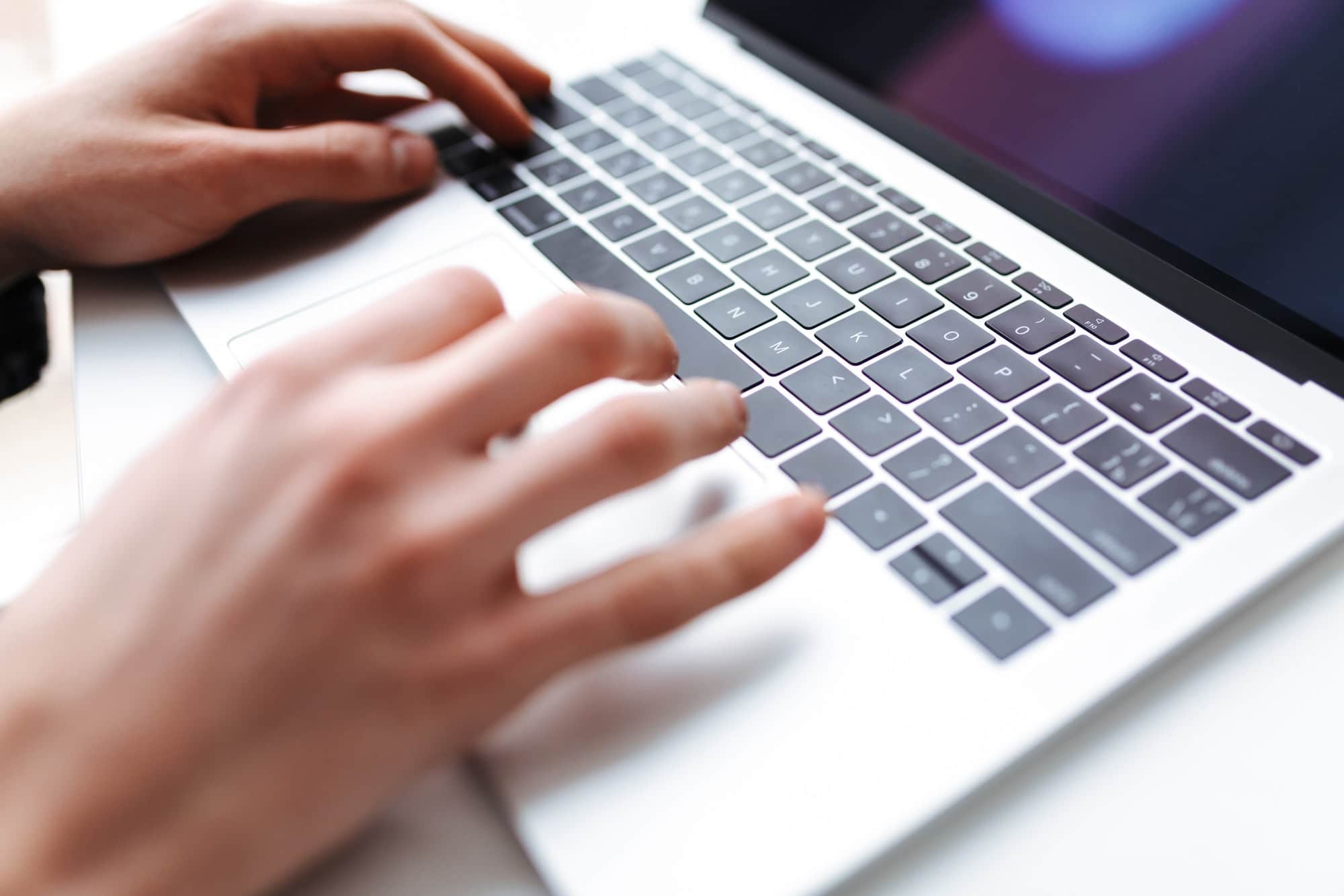 Photo of man hands typing on laptop