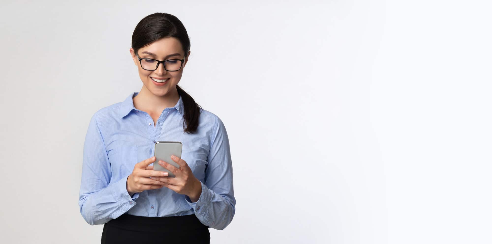 Business Girl Browsing On Smartphone Standing Over White Background